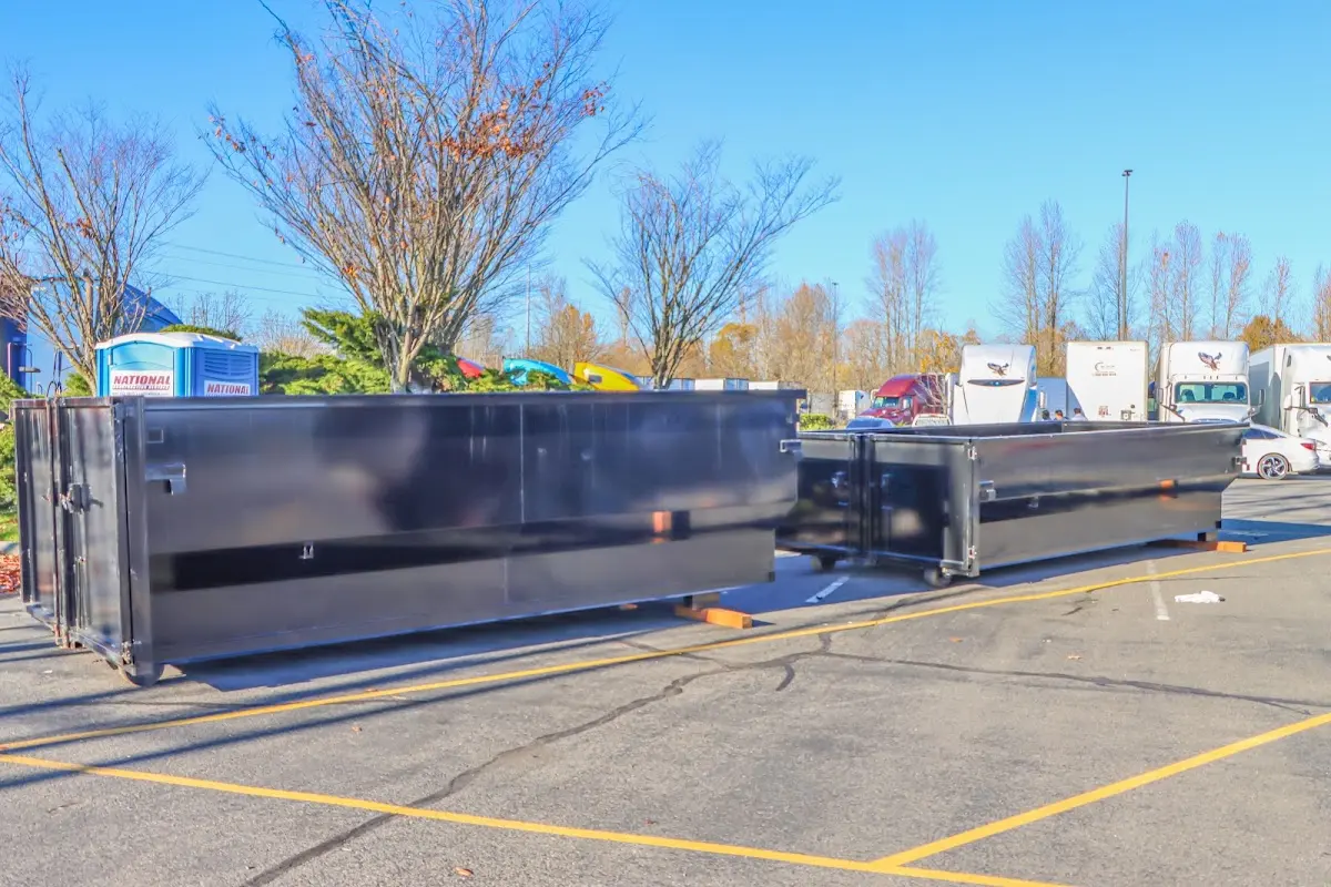 Professional dumpster rental service with roll-off container on residential driveway in South Union